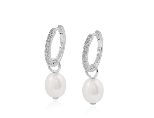 Silver hoop earrings with pearl drops on a white background